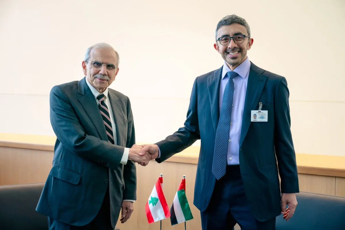 H.E. Dr. Nawaf Salam and H.H. Sheikh Abdullah bin Zayed Al Nahyan shaking hands in front of the Lebanese and UAE flags in New York