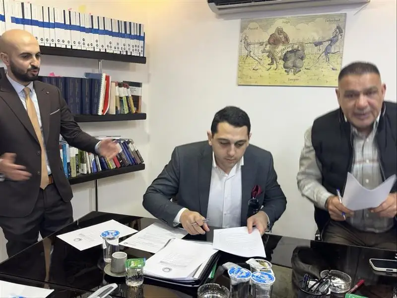 Antoine Kanaan signing the partnership agreement